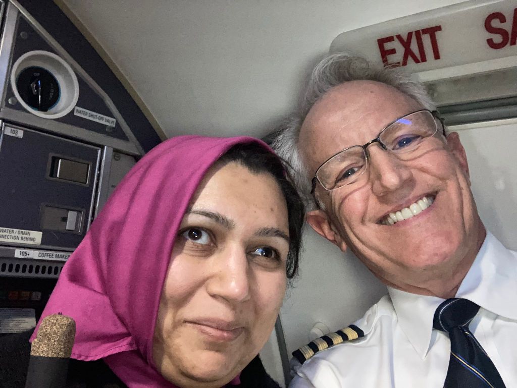 From left to right: The Blind Hijabi (Mariyam) and the pilot smile at the camera.